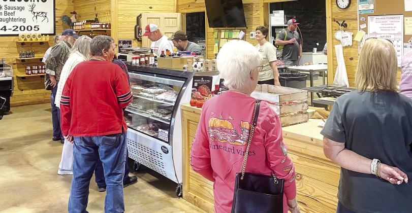 Customers stand in line to order meat inside C&amp;B Meat Market, the host of the festival. Their selection included samples of their finest meats, including hotdogs, hamburgers, sausages, and more. HANNAH MITCHELL/Staff
