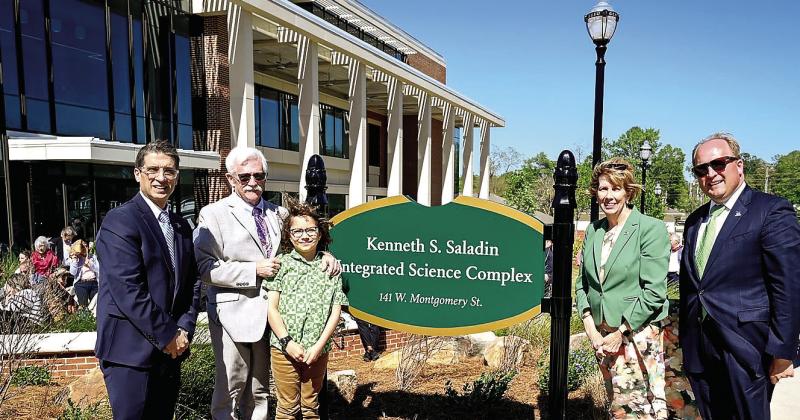 From left: Provost Dr. Costas Spirou, Dr. Kenneth Saladin with his grandson, GCSU President Cathy Cox and Vice President of University Advancement Seth Walker stand by the new sign for the Kenneth S. Saladin Integrated Science Complex. COURTESY OF GCSU