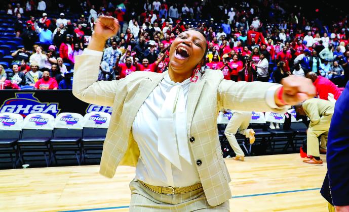 Baldwin High School head coach Kizzi Walker celebrates the Bravettes victory at the state championship. CONTRIBUTED