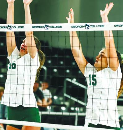 Brooke Roberts (left) and Callie Miller go up for the block. COURTESY OF GC ATHLETICS
